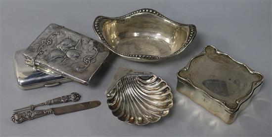A George V silver trinket box, two silver dishes, two silver cases including Comyns card case and a knife and fork set